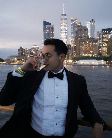Agung in a tuxedo on the Hudson, Lower Manhattan behind